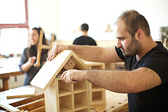 Menschen bei einer Maßnahme zur beruflichen Eingliederung